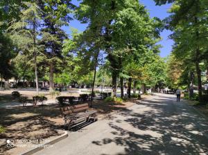 a park with benches and trees on a sidewalk at Giravolta (Jaco) in Sulmona