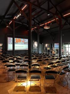 an empty room with chairs and a projection screen at Hoeve La Cascina in Deinze +58 photos