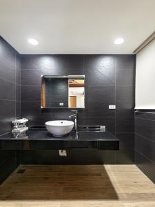 a bathroom with a sink and a mirror at Caolingdai BnB in Gukeng