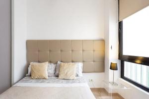a bedroom with a large bed with a large headboard at Plaza del Príncipe in Santa Cruz de Tenerife