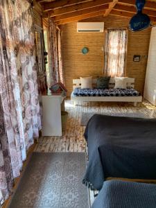 a bedroom with two beds in a wooden room at Bamboo Bungalow with Sea View in Kabak Bay, Ölüdeniz in Fethiye
