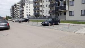 a row of cars parked in a parking lot at Nowoczesny dwupokojowy Apartament Bridget z parkingiem in Ełk