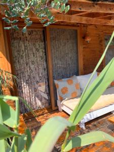 a porch of a house with a bed in it at Bamboo Bungalow with Sea View in Kabak Bay, Ölüdeniz in Fethiye