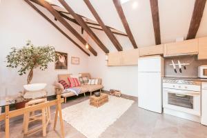 a kitchen and living room with a couch and a table at Bohemian 2bedroom attic in Lavapies in Madrid