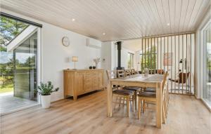 a dining room with a table and chairs at Holiday Home Karensvej in Grønhøj