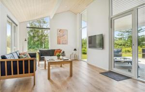 a living room with a couch and a table at Holiday Home Karensvej in Grønhøj