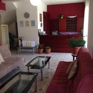 a living room with couches and tables in a room at Zefyros Hotel in Rhodes Town