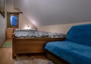 a bedroom with a bed with a blue comforter at Holiday Home Mirt with HotTub & Sauna in Blanca +37 photos