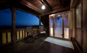a room with two chairs on a balcony at night at Holiday Home Mirt with HotTub & Sauna in Blanca