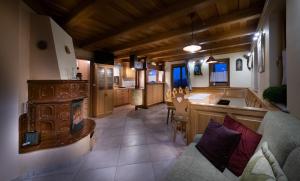 a living room with a fireplace and a kitchen with a couch at Holiday Home Mirt with HotTub & Sauna in Blanca
