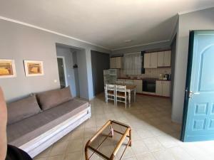 a living room with a couch and a kitchen at Sivota Muses in Syvota