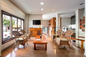 a living room with chairs and a table at Hotel Dom Rafael Express in Santa Maria
