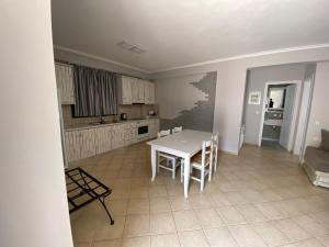 a kitchen and dining room with a table and chairs at Sivota Muses in Syvota +21 photos