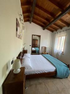 a bedroom with a bed and a table and a mirror at OASI DEL GARDA 6 in Monzambano