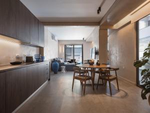 a kitchen and living room with a table and chairs at Grand Residences in Chania