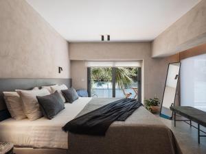 a bedroom with a large bed with a large window at Grand Residences in Chania