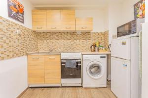 una cocina con lavadora y nevera en Captain's Residence in Soho, en Budapest 16 fotos más