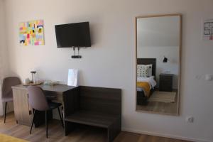 a mirror in a room with a desk and a bed at House Štefanac in Seliste Dreznicko