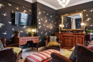 a living room with a tv and a mirror at The Snug @ Clarence in Derry Londonderry