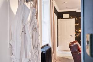 a robe hanging on a wall in a room at The Snug @ Clarence in Derry Londonderry