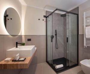 a bathroom with a sink and a shower at MEM Lodge and Suite in Pula