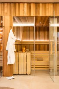 a bedroom with a bed and a white coat on a rack at Casa Bodhi Boutique Hotel & Spa in Marbella