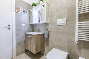 a bathroom with a toilet and a sink and a mirror at Divi Apartments Milano - Strategic Place in Milan +27 photos