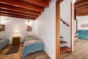 a bedroom with two twin beds and a staircase at Casita Ana in El Paso