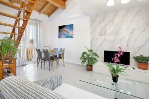 uma sala de estar com uma mesa e uma televisão em Casa Global Atlantica em Nova Milanese