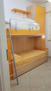 two bunk beds in a room with yellow walls at Appartamenti Rosa Virginia by Salentoville Gallipoli in Gallipoli