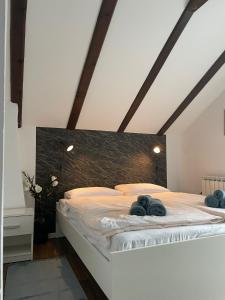 a bedroom with a bed with two stuffed animals on it at Kuća za odmor - Agatha - Bjelolasica in Jasenak