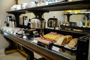 a breakfast buffet with meats and cheese and bread at Amérian Executive Córdoba Hotel in Córdoba
