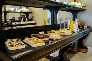 a buffet with many different types of desserts on a table at Amérian Executive Córdoba Hotel in Córdoba