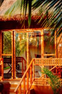 a cabin with a staircase and a room with windows at PALM CULTURAL VILLAGE in Paje