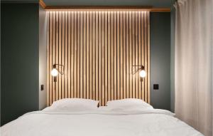 a bedroom with a large bed with two white pillows at Awesome Home In Etne With Sauna in Etnesjøen +6 photos