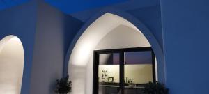 a blue wall with a mirror in a room at Artium Villa with Outdoor Pool hosted by K&K in Foinikiá