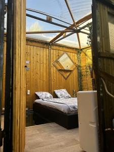 a bedroom with a bed in a wooden house at l'aquarium in Brignoles