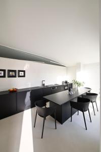 a kitchen with tables and chairs and a sink at Artium Villa with Outdoor Pool hosted by K&K in Foinikiá +35 photos