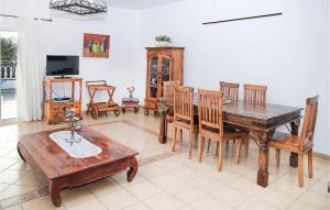 a dining room with a wooden table and chairs at Villas Del Mar in Puerto Calero