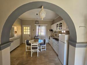 an archway in a kitchen with a table and chairs at Tondoris Apartments in Sidari