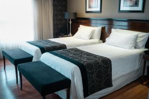 a hotel room with two beds and a window at Amérian Executive Córdoba Hotel in Córdoba