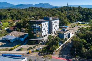 an aerial view of a building with a parking lot at Naalt Hotel Joinville in Joinville