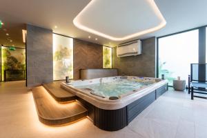 a large bathroom with a large soaking tub at Rókusfalvy Borhotel és Fogadó in Etyek