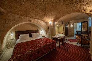 a bedroom with a bed in a stone room at Shiraz Cave Cappadocia in Urgup