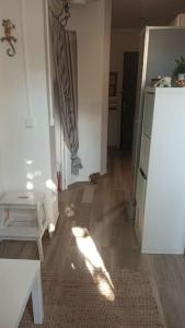 a room with a white refrigerator and a wooden floor at Cozy Studio*Near Paris*Ideal Couple in Boulogne-Billancourt