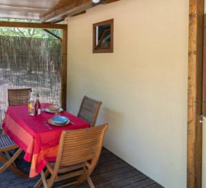 una mesa con un mantel rojo en el patio en TENUTA IL GUERRIERO, en Capestrano