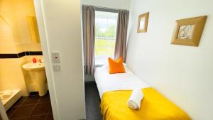 a small room with a bed and a window at Pentland Farm Cottage Annex in Kirknewton