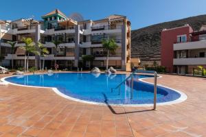 a large swimming pool in front of a building at Villa with private pool and beautiful garden in Los Cristianos