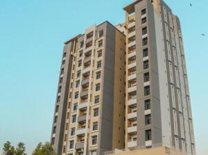 a tall building with balconies on the side of it at Ghumo - 3BR APT Main Shahrah-e-Faisal in Karachi