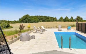 a patio with a swimming pool and chairs next to a field at Amazing Home In Stare Sady With Wifi in Stare Sady